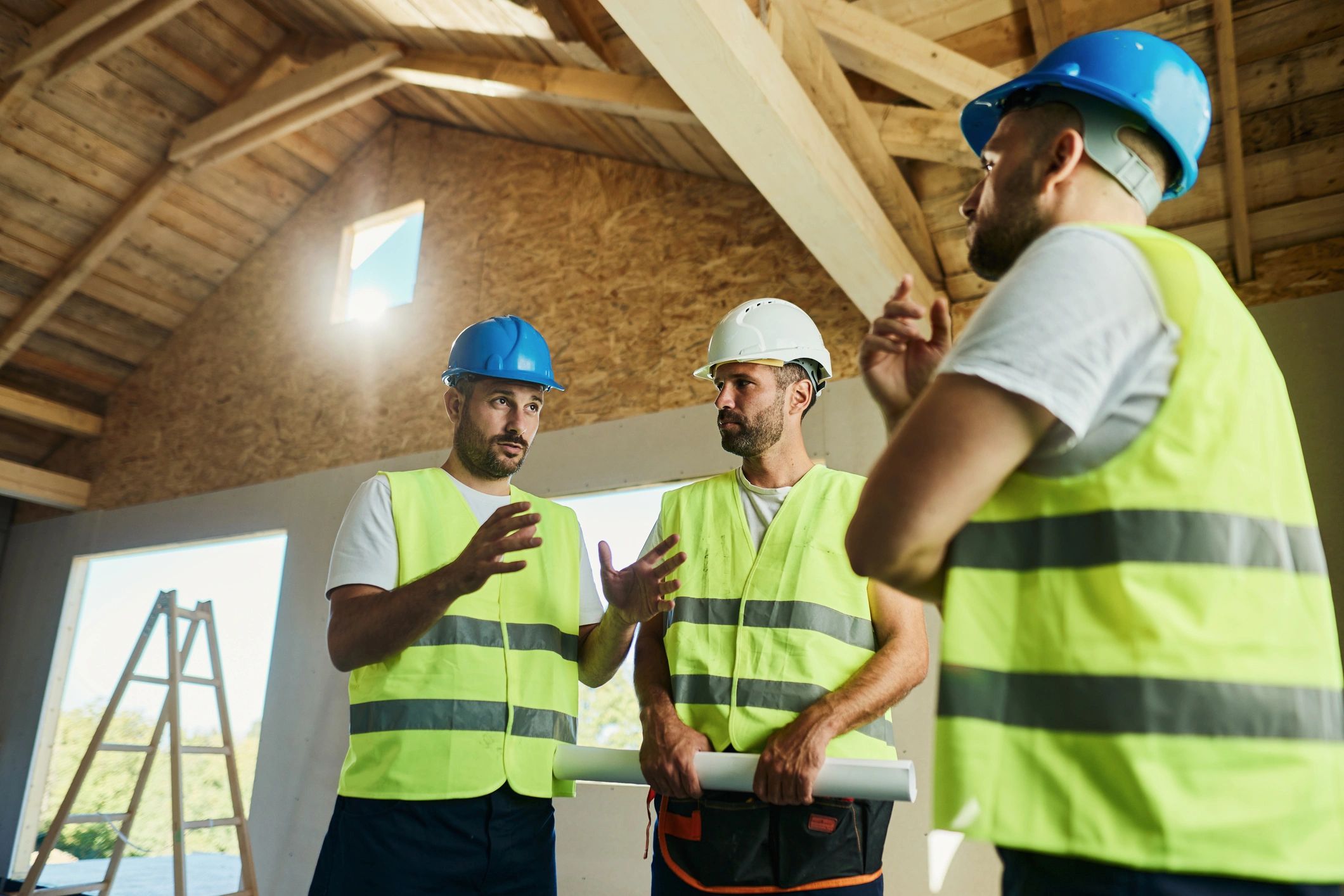 Construction workers reviewing blueprints